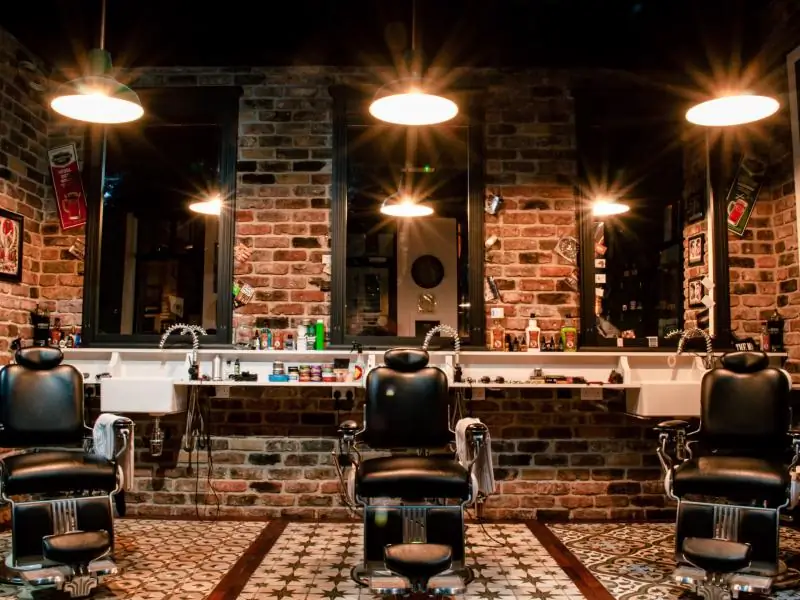 Leather barber chair by a brick wall