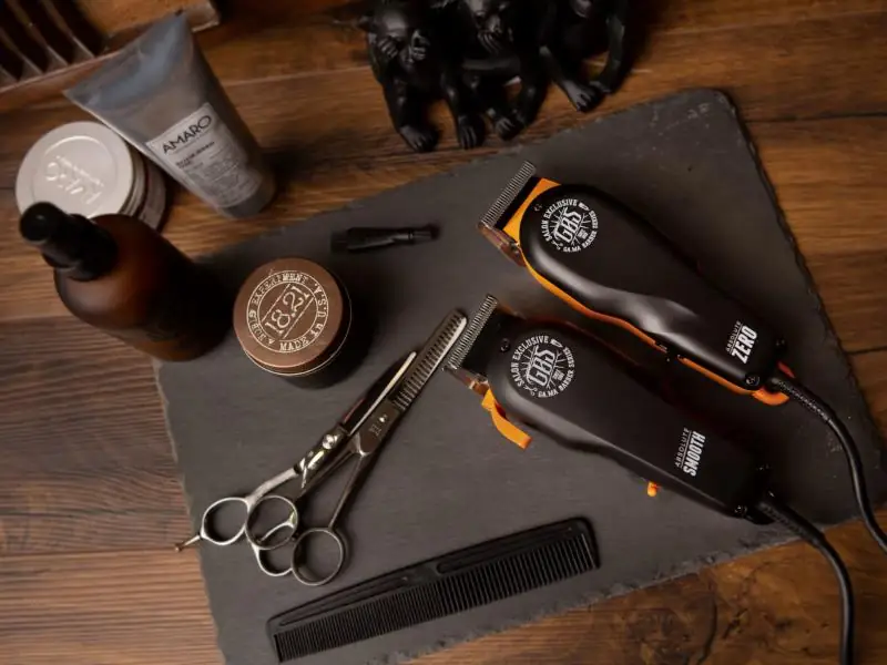 Clippers, scissors and a comb on slate